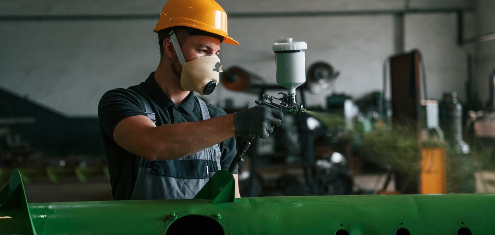 WIPCO technician applying protective coating to industrial equipment